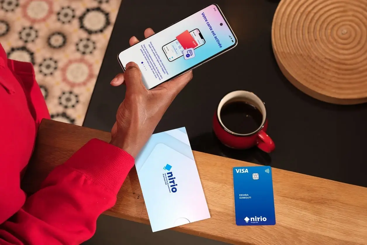 Un buraliste aidant un client à ouvrir un compte NIRIO